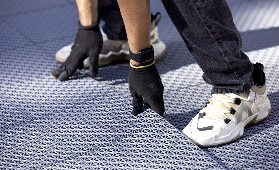 VersaCourt team installing court tiles in the Maxx Crosby's backyard