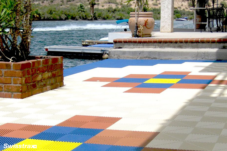 Lakeside backyard with tile flooring around the pool