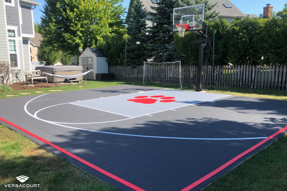 Small backyard basketball half court with a custom logo