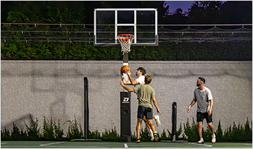 men playing basketball in front of a Dominator basketball goal with optional accessory add-ons