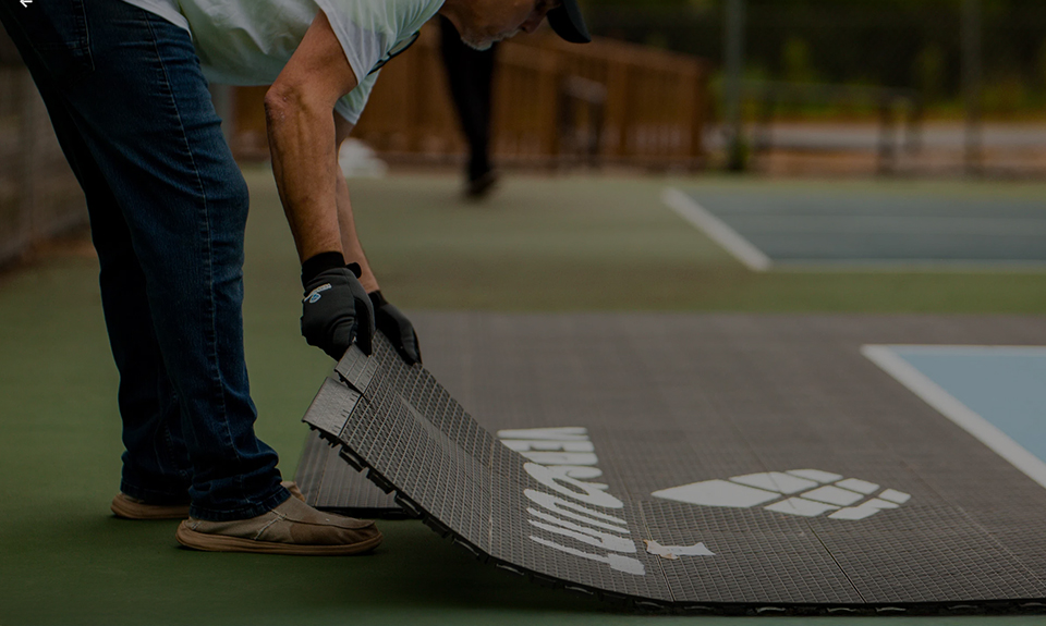 Video of a temporary pickleball court being assembled and disassembled